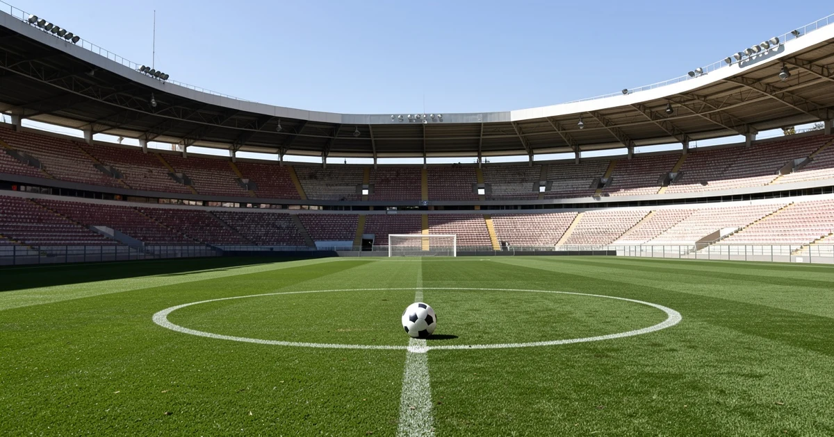Estadio de fútbol vacío con césped y balón en el centro del campo