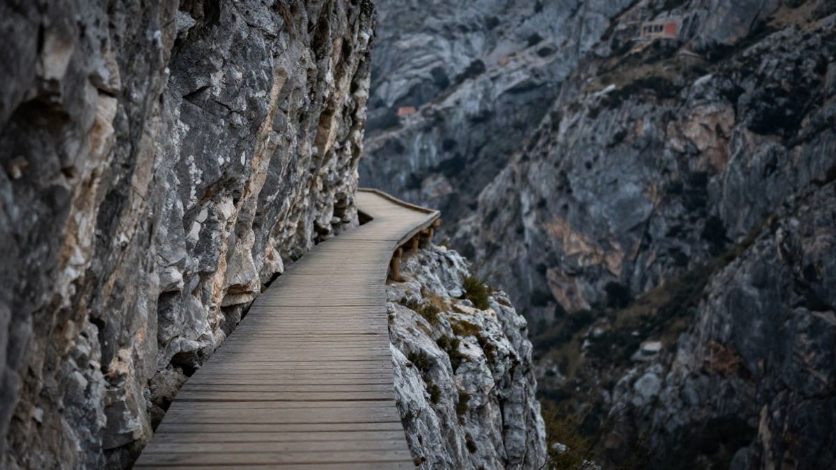 Illustrative image: wooden walkway attached to the wall of a rocky gorge