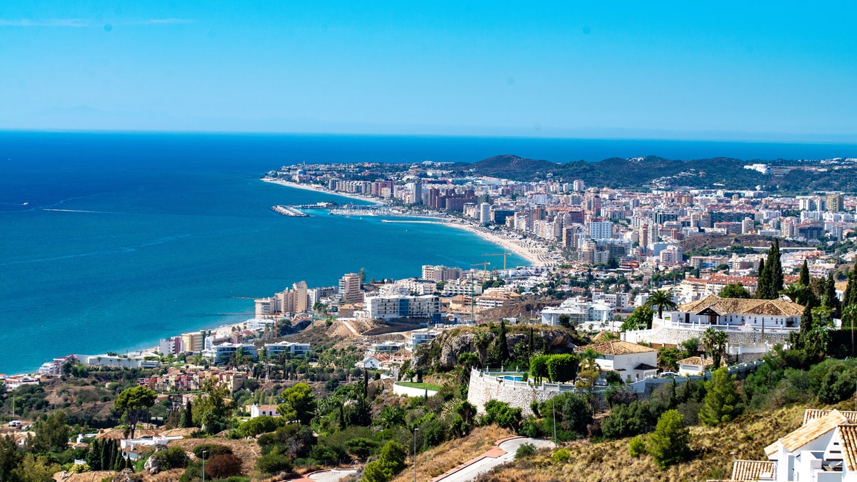 Aerial view of Fuengirola from a hill, featuring the coast, the port, and the city.