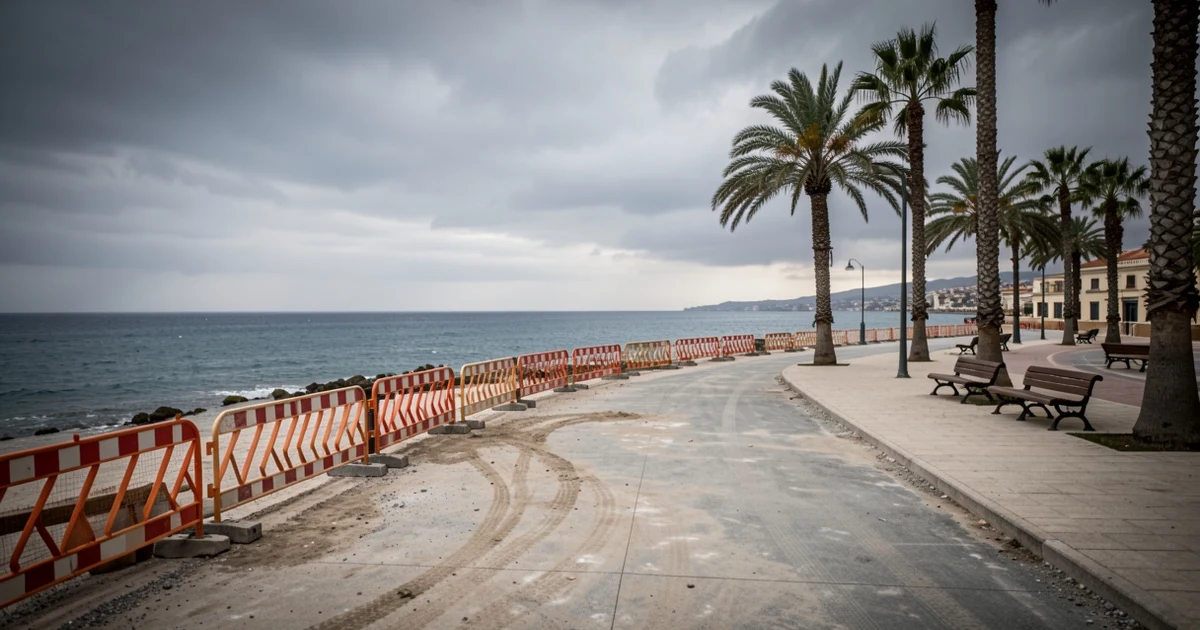 Promenade under construction with barriers and unfinished ground, with the Mediterranean Sea in the background